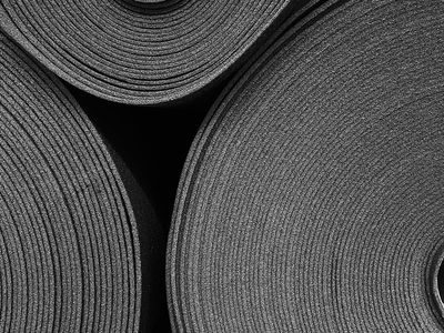 Stacked yoga blocks and a rolled mat on floor.